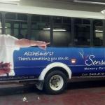 Curbside bus ad for Sensations Memory Care on the EATRAN buses Charlotte, Michigan.