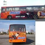 A full bus wrap.  All the people are eating snickers (and are see through graphics).  I like the guy in the back reaching for the person hanging on for dear life.  A cool effect!

3D effects are great tools for getting your ad noticed.  Call us!  How might we design a bus ad for your business? 