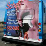 That's one big ear!  Rear ad for Schell Hearing Aid Service on an ITC bus in Tawas Michigan.